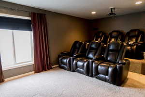 Home theater with recessed lighting, carpet flooring, and baseboards