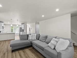 Living room featuring recessed lighting, stairway, and light wood finished floors