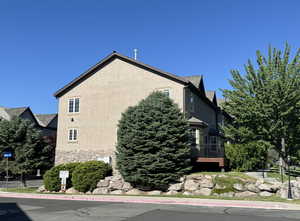 View of side of home with stone siding and stucco siding