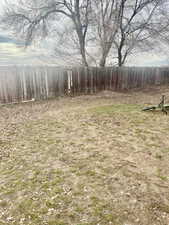 View of yard featuring fence