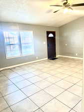 Foyer with a ceiling fan and baseboards