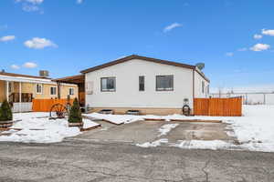 View of snow covered rear of property