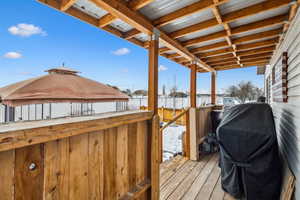Wooden deck featuring area for grilling