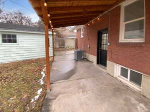 View of patio / terrace with central AC and fence