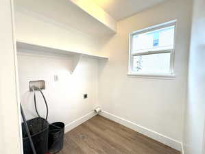 Washroom featuring laundry area, baseboards, wood finished floors, washer hookup, and electric dryer hookup