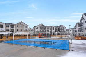 View of swimming pool with a residential view and fence