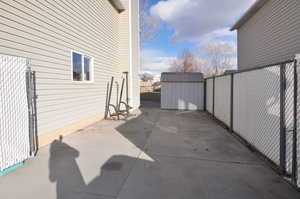 View of patio / terrace featuring a fenced backyard, an outdoor structure, and a shed