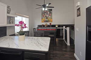 Kitchen with ceiling fan, baseboards, white cabinets, open shelves, and dark wood finished floors