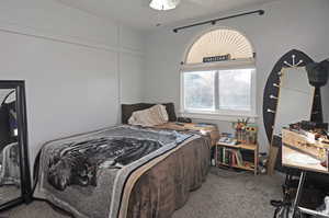 Bedroom featuring ceiling fan and carpet