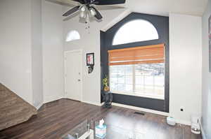 Foyer entrance with dark wood-style flooring, visible vents, plenty of natural light, and baseboards