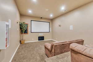 Carpeted home theater featuring recessed lighting, visible vents, and baseboards