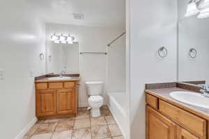 Bathroom featuring two vanities, tile patterned flooring, visible vents, and a sink