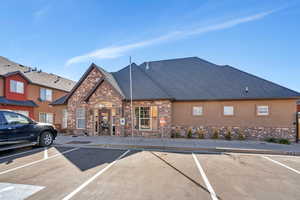 View of building exterior featuring uncovered parking