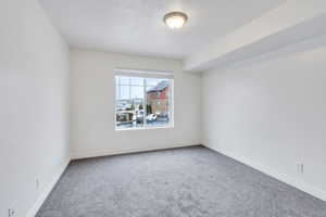 Empty room featuring baseboards and carpet flooring