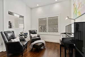 Sitting room featuring recessed lighting, dark wood finished floors, and baseboards