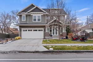 2 Story  home with board and batten siding, concrete driveway, and an attached garage