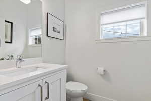 Half bath with vanity and toilet