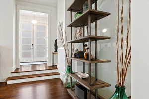 Entrance foyer with dark wood-style floors and french doors