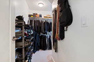 Spacious walk in closet with carpet