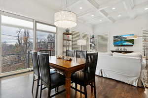 Dining area with recessed lighting, coffered ceiling, beam ceiling, and wood finished floors