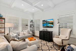 Living area with recessed lighting, beamed ceiling, coffered ceiling, and light wood-style floors