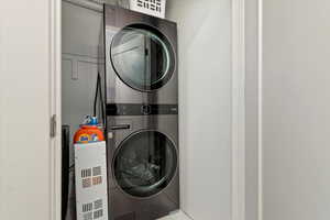 Laundry room featuring stacked washing maching and dryer and laundry area