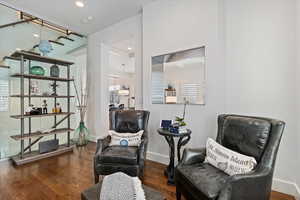 Sitting room featuring baseboards, dark wood finished floors, and recessed lighting