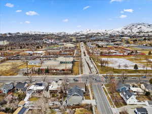 Snowy aerial view with a residential view and a mountain view