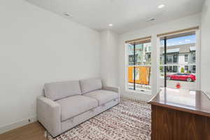 Living area with light wood finished floors, a wealth of natural light, and visible vents
