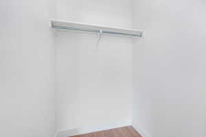 Spacious closet with light wood finished floors