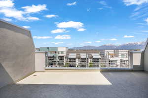 View of patio / terrace with a mountain view and a balcony