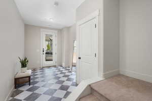 Foyer with dark floors and baseboards