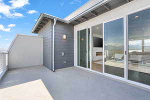 View of patio with a balcony