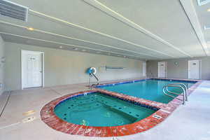 Community pool featuring an indoor hot tub