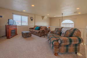 Living room featuring light carpet, a healthy amount of sunlight, and recessed lighting