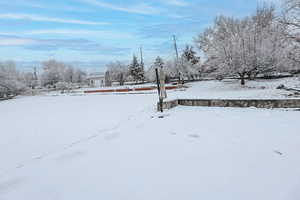 Snowy yard featuring a garage