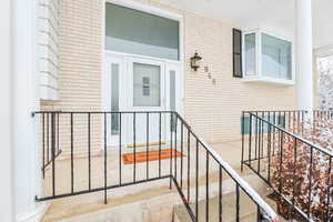 Property entrance featuring brick siding