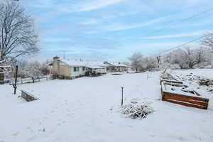 Snowy yard featuring a garage