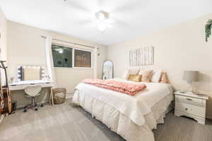 Bedroom with carpet floors, a ceiling fan, and baseboards