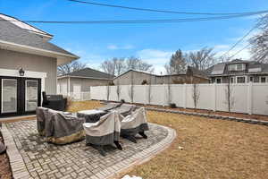 View of yard with french doors, a patio area, and a fenced backyard