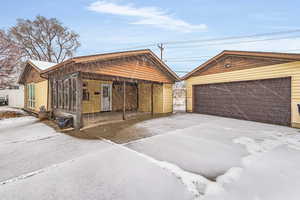 Exterior space with a detached garage and an outdoor structure
