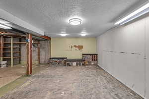 Finished below grade area featuring a textured ceiling