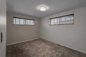 Carpeted  bedroom with big windows