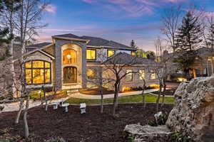 View of front of house with a shingled roof and brick siding