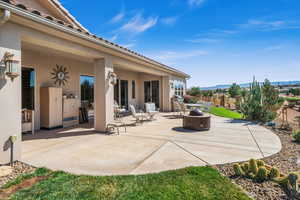 View of patio / terrace featuring fence and a fire pit