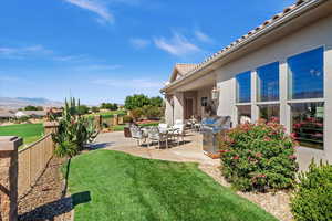 View of yard with a patio, a fenced backyard, and a mountain view