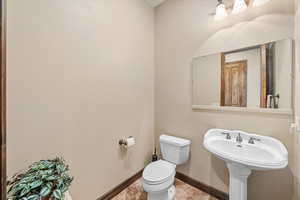 Bathroom featuring toilet and baseboards