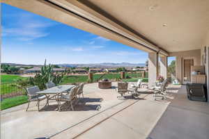 View of patio featuring outdoor dining space, a mountain view, and fence