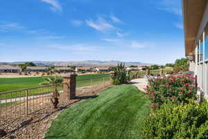 View of yard featuring fence and a mountain view