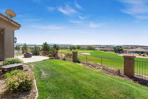 View of yard with a fenced backyard and a patio